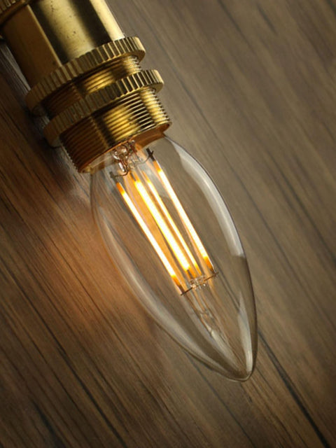 Tatva Lights E14 LED filament bulb with amber glow, vintage candle-shaped design, ideal for decorative lamps, wall sconces, and ambient home lighting.