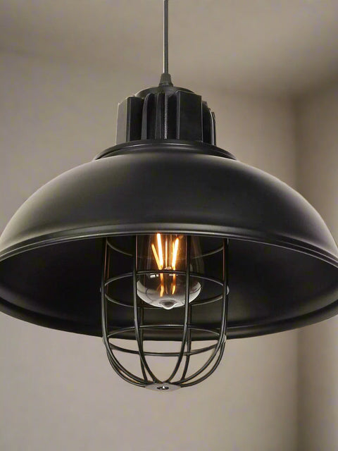 Tatva Lights industrial-style black metal cage pendant lamp with vintage Edison bulb – perfect for lofts, cafes, and rustic modern interiors