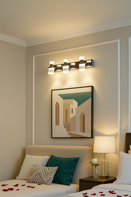 Modern bedroom with Tatva Lights wall-mounted vanity fixture above abstract artwork, featuring four frosted glass lamps on a sleek chrome base, casting warm ambient lighting
