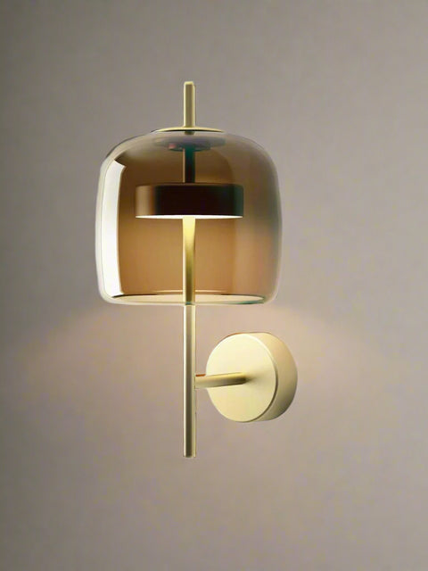 A modern amber glass wall sconce with a brushed gold metal frame, perfect for ambient lighting in living rooms, bedrooms, or hallways – Tatva AuraGlow designer wall light