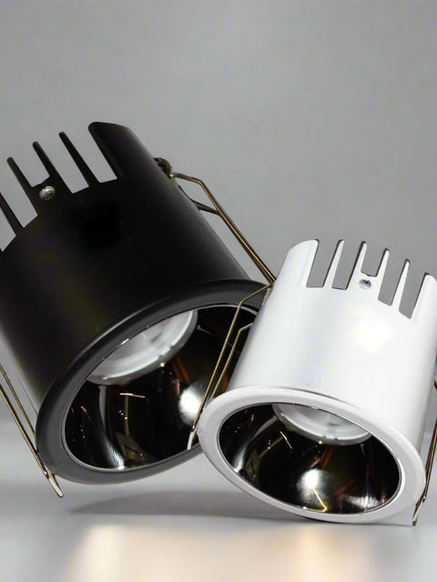 Close-up view of Tatva DualTone Recessed LED Downlights in black and white finishes, featuring heat-dissipating fins and high-efficiency reflectors for focused illumination in modern interiors.