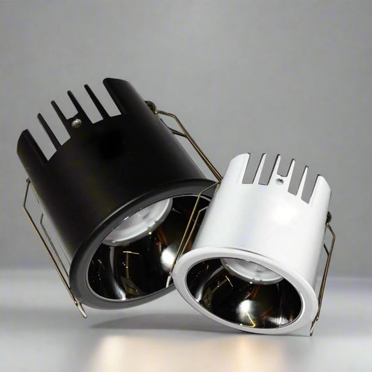 Close-up view of Tatva DualTone Recessed LED Downlights in black and white finishes, featuring heat-dissipating fins and high-efficiency reflectors for focused illumination in modern interiors.