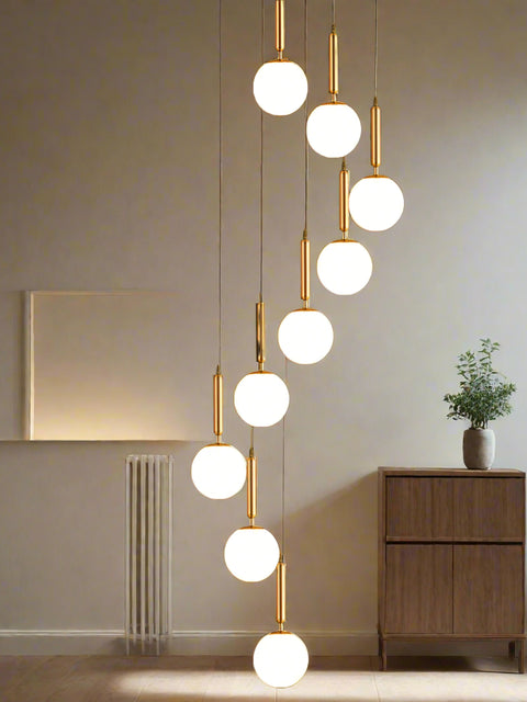 **Alt Text:**
Tatva Lights 10-Light Staircase & Double-Height Chandelier with cascading pendant lights in a modern minimalist design, perfect for illuminating stairwells, double-height ceilings, or grand entrances with a luxurious ambient glow.