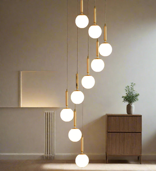 **Alt Text:**
Tatva Lights 10-Light Staircase & Double-Height Chandelier with cascading pendant lights in a modern minimalist design, perfect for illuminating stairwells, double-height ceilings, or grand entrances with a luxurious ambient glow.