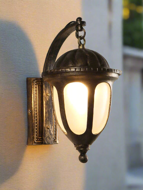 Tatva Lights Antique Glow outdoor wall light with a vintage bronze finish and clear glass panels, blending classic charm with warm illumination for timeless exteriors.