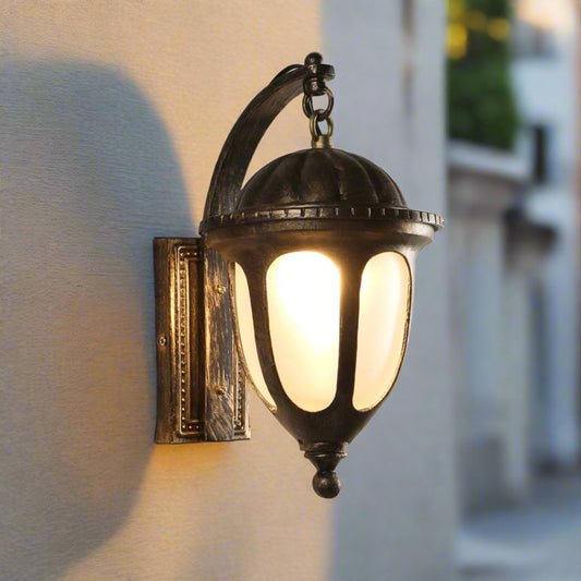 Tatva Lights Antique Glow outdoor wall light with a vintage bronze finish and clear glass panels, blending classic charm with warm illumination for timeless exteriors.