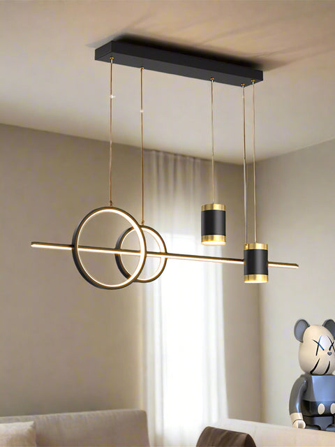 Tatva Lights modern geometric LED chandelier with circular and cylindrical pendant elements,  ideal for dining areas, living rooms, or contemporary interior spaces.