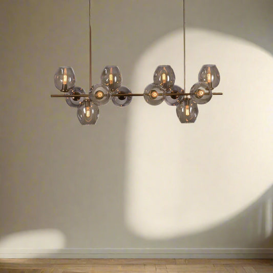 Tatva Lights Caelus Grey Glass Chandelier featuring a cluster of smokey grey glass orbs with a matte black or gold metal frame and integrated LED lighting—ideal for modern living rooms, dining spaces, or contemporary lounges seeking a refined, ambient glow.