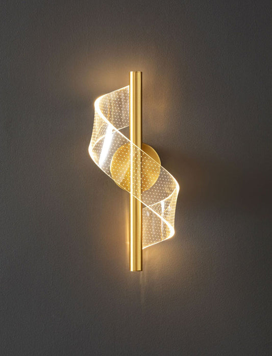 A modern industrial LED wall sconce with a gold finish and mesh diffuser, providing warm white illumination.