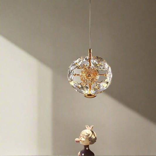 Tatva Lights Crystique Gold Pendant Chandelier features a luxurious gold frame adorned with cascading crystal accents, delivering a radiant and elegant glow—perfect for upscale dining rooms, living spaces, or entryways.