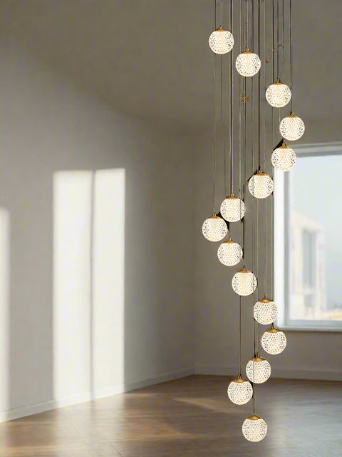 Tatva Lights Elarin Spiral Chandelier featuring a cascading spiral design with suspended crystal elements and integrated LED illumination—perfect for grand staircases, double-height foyers, or luxurious contemporary interiors.