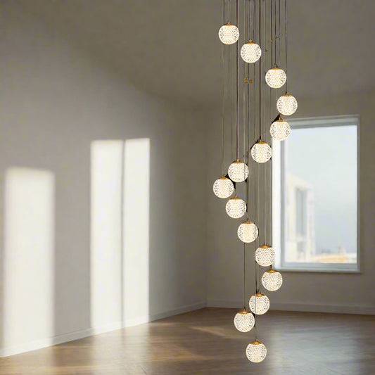 Tatva Lights Elarin Spiral Chandelier featuring a cascading spiral design with suspended crystal elements and integrated LED illumination—perfect for grand staircases, double-height foyers, or luxurious contemporary interiors.