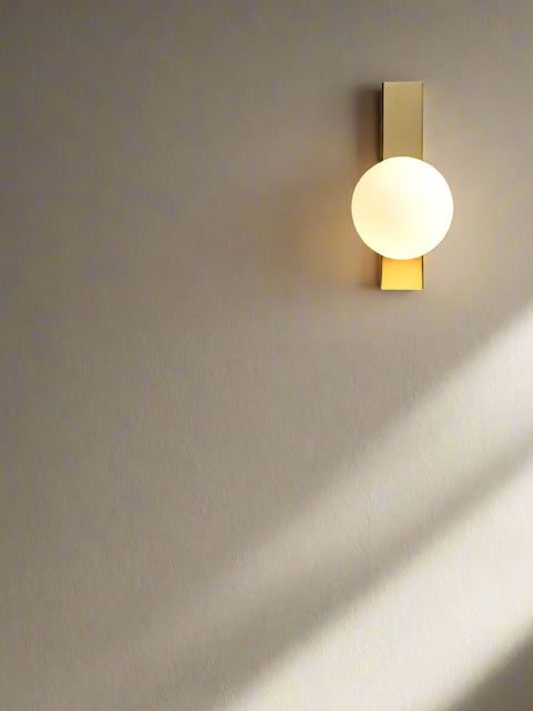 Tatva Lights Feroux Gold Glass Iron Wall Light – Stylish wall sconce with a clear glass shade and gold-finished iron frame, perfect for contemporary bedrooms, living rooms, and elegant hallway lighting