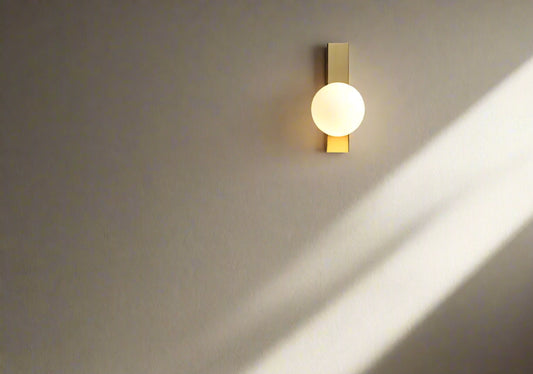 Tatva Lights Feroux Gold Glass Iron Wall Light – Stylish wall sconce with a clear glass shade and gold-finished iron frame, perfect for contemporary bedrooms, living rooms, and elegant hallway lighting