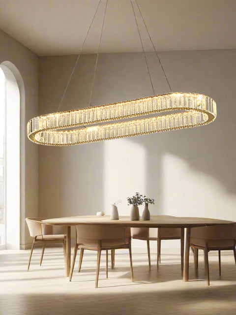 Tatva Lights Florenza Raindrop Chandelier featuring cascading crystal raindrop elements suspended from a polished gold frame with integrated LED lighting—ideal for grand foyers, staircases, or luxurious dining spaces.