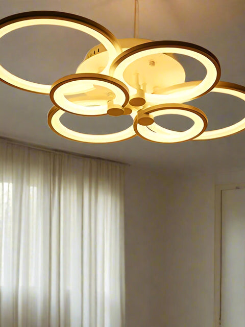 Tatva Lights Florize Hexa Chandelier featuring a geometric hexagonal arrangement of crystal-embedded rings with a gold finish and integrated LED lights—ideal for contemporary living rooms, dining spaces, or high-ceiling entryways seeking a bold yet elegant statement.