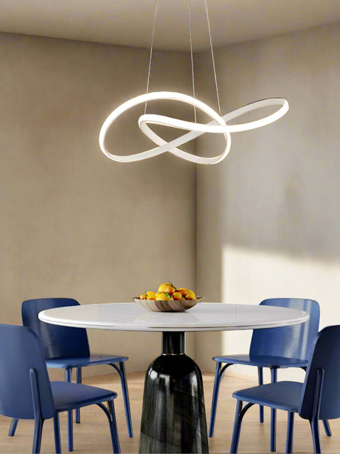 Tatva Lights Gilded Loop LED Pendant features an elegant looping gold frame with integrated LED illumination, ideal for adding a modern luxurious touch to dining areas, living rooms, or entryways.
