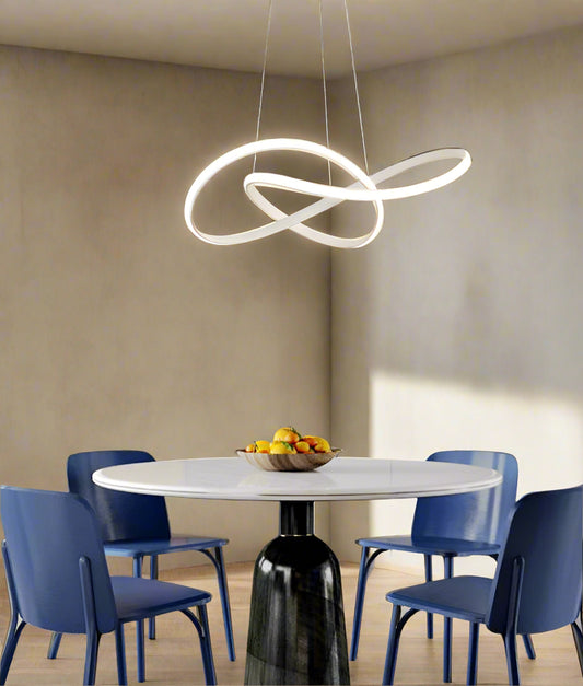 Tatva Lights Gilded Loop LED Pendant features an elegant looping gold frame with integrated LED illumination, ideal for adding a modern luxurious touch to dining areas, living rooms, or entryways.