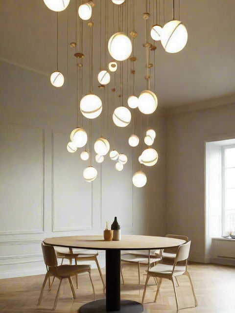 Tatva Lights 3-light modern globe pendant with sleek gold accents and frosted glass orbs – ideal for ambient lighting in kitchens, dining areas, and living spaces