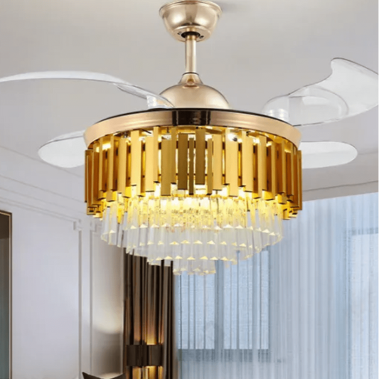 A luxurious golden crystal ceiling fan with an chandelier-style light fixture, featuring automatic retractable fan blades and a remote control, installed in a living room setting.