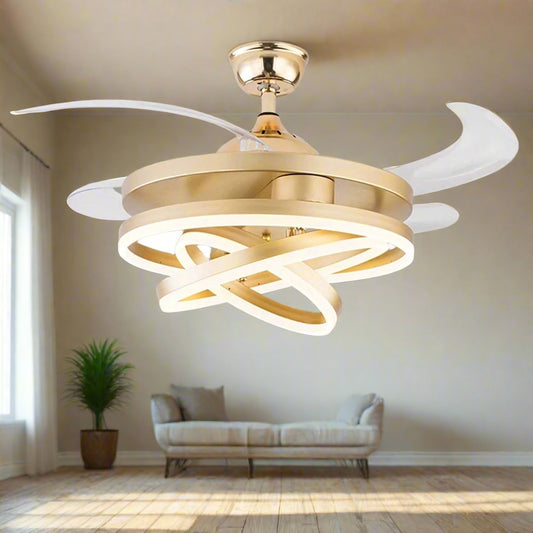 Tatva Lights Modern Gold Ceiling Fan with Retractable Blades and Integrated LED Light. Features a sculptural, intertwined LED ring design and a sleek metallic gold finish, ideal for luxury interiors.