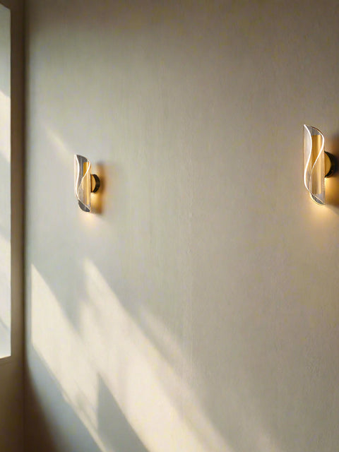 Tatva Lights Modern Industrial LED Wall Sconce featuring a matte black metal frame with a cylindrical clear glass shade, delivering focused, ambient lighting ideal for hallways, bedrooms, or modern living spaces.