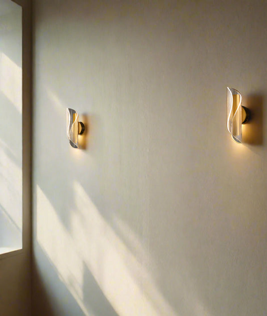 Tatva Lights Modern Industrial LED Wall Sconce featuring a matte black metal frame with a cylindrical clear glass shade, delivering focused, ambient lighting ideal for hallways, bedrooms, or modern living spaces.