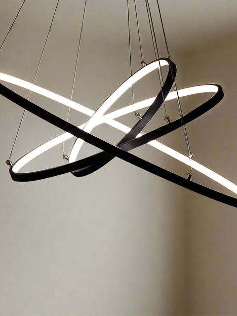 Tatva Lights Modern Zenith Chandelier – striking contemporary chandelier with a bold geometric structure and integrated LED lighting, finished in elegant gold. Perfect for high ceilings, luxury dining areas, and statement living room décor.