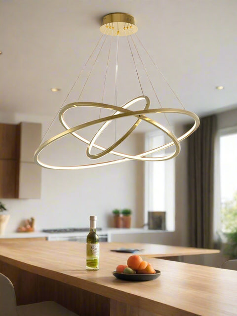 Tatva Lights Nehza Ring Chandelier – modern circular chandelier featuring a sleek metallic ring with integrated LED lighting, suspended by adjustable cables. Ideal for contemporary dining areas, living rooms, and double-height ceilings seeking a minimalist yet striking lighting centerpiece.