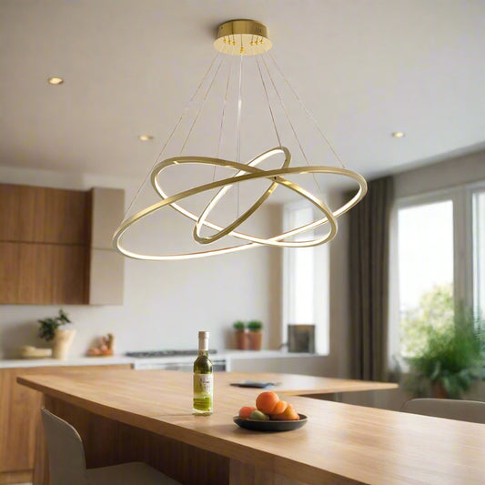 Tatva Lights Nehza Ring Chandelier – modern circular chandelier featuring a sleek metallic ring with integrated LED lighting, suspended by adjustable cables. Ideal for contemporary dining areas, living rooms, and double-height ceilings seeking a minimalist yet striking lighting centerpiece.