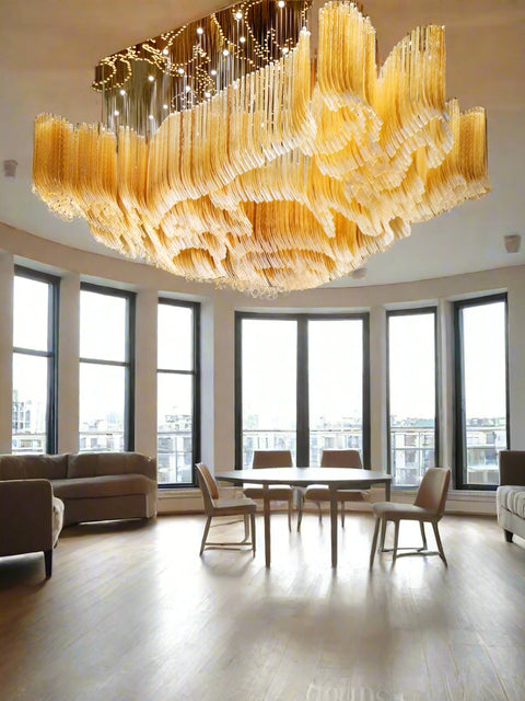 Tatva Lights Optiglo Customised Chandelier – Grand sculptural chandelier with cascading crystal-like elements in golden tones, designed for opulent hotel lobbies, ballrooms, or luxury residences. Tailored elegance with modern craftsmanship for large-scale architectural spaces.