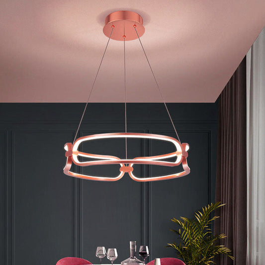 Tatva Lights Oralie Curve Chandelier featuring a gracefully curved metallic frame with integrated LED illumination and a sleek gold finish—perfect for contemporary dining areas, living rooms, or statement ceiling spaces.