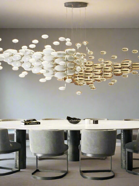 Tatva Lights Orbis Shell Chandelier featuring layered, iridescent shell discs arranged in a circular form with warm LED illumination—ideal for coastal-themed interiors, elegant bedrooms, or sophisticated dining areas seeking a soft, organic glow.