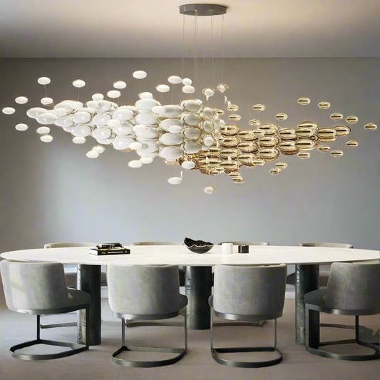 Tatva Lights Orbis Shell Chandelier featuring layered, iridescent shell discs arranged in a circular form with warm LED illumination—ideal for coastal-themed interiors, elegant bedrooms, or sophisticated dining areas seeking a soft, organic glow.