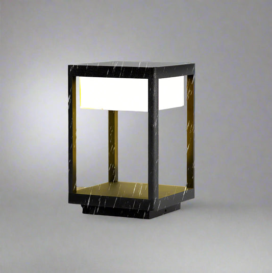 Tatva Lights Outdoor Pillar Lantern featuring a robust weather-resistant frame with clear glass panels and warm LED lighting—perfect for illuminating garden paths, gateposts, or patio pillars in modern outdoor settings.