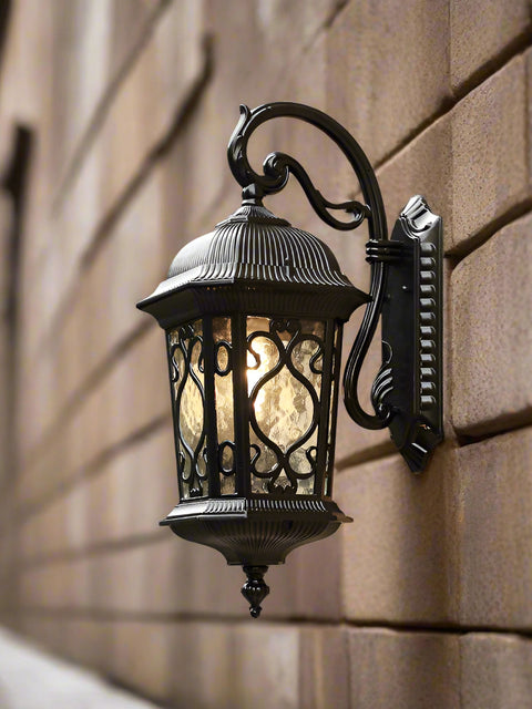 Tatva Lights ShadowBeam outdoor wall lantern with a sleek black finish and frosted glass panels, designed to cast a warm, diffused glow ideal for patios, gardens, and entrances.