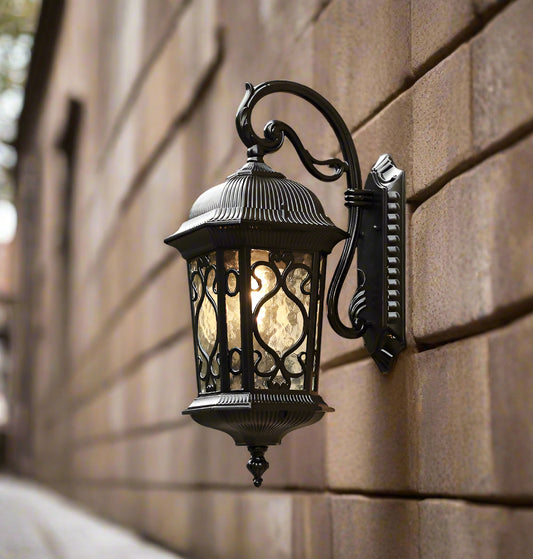 Tatva Lights ShadowBeam outdoor wall lantern with a sleek black finish and frosted glass panels, designed to cast a warm, diffused glow ideal for patios, gardens, and entrances.
