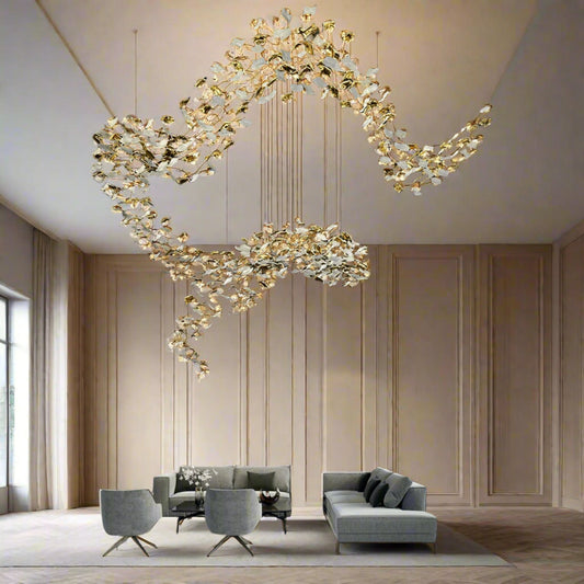 Tatva Lights – Shunya Chandelier featuring a striking circular design with suspended LED rings, exuding a sense of minimal elegance and modern sophistication. Finished in a premium metallic tone, perfect for double-height spaces or statement ceilings.