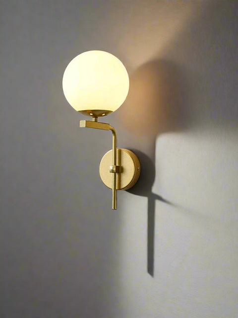 Tatva Lights Sorelle Frost Gold Glass Ball Wall Light – Elegant wall sconce featuring a frosted glass globe and gold-finish frame, ideal for modern bedrooms, hallways, and luxe interior accents