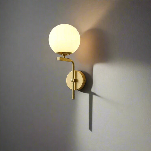 Tatva Lights Sorelle Frost Gold Glass Ball Wall Light โ Elegant wall sconce featuring a frosted glass globe and gold-finish frame, ideal for modern bedrooms, hallways, and luxe interior accents