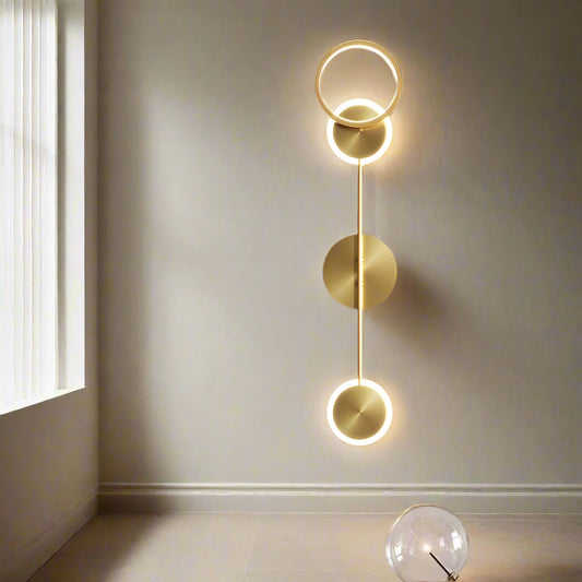 Tatva Lights Trivara Wall Light – Contemporary triple-arm LED wall sconce with a sleek gold and black finish, ideal for modern living rooms, bedrooms, hallways, or statement accent walls