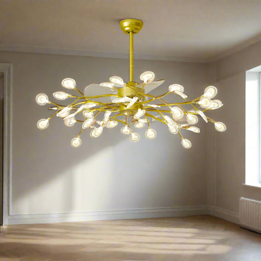 A ceiling-mounted fan chandelier with gold-colored lights and retractable blades, installed in a modern living room setting.