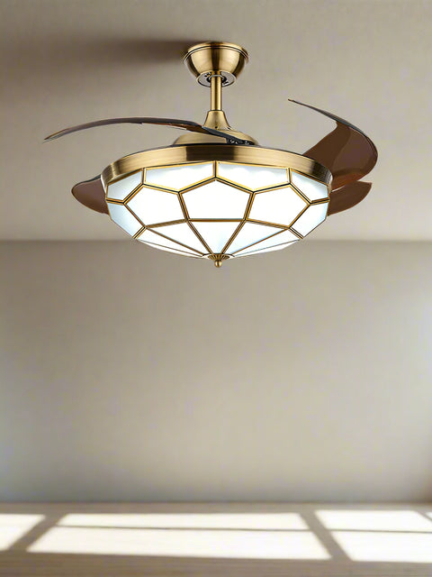 Tatva Lights Vintage Crystal Ceiling Fan with Light featuring a stunning gold geometric crystal diffuser and retractable blades.
Combines elegant chandelier lighting with a quiet, high-performance ceiling fan for living or dining rooms.
Perfect fusion of style and utility for modern or vintage-inspired interiors seeking luxury ceiling decor.