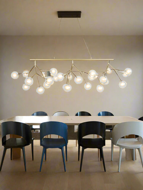 Tatva Lights Écloré Noir Glass Chandelier featuring smoky black glass globes and a sleek gold metal frame with integrated LED lighting—perfect for modern dining areas, living rooms, or upscale interior spaces seeking a bold, elegant touch