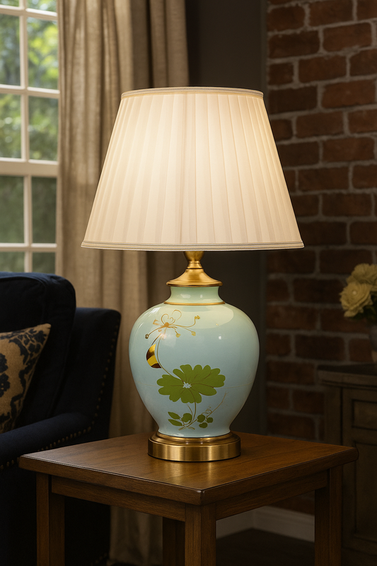 Tatva Lights Blossom Ceramic Table Lamp featuring a hand-painted floral design on a glossy ceramic base with gold accents, topped with a pleated ivory lampshade—perfect for adding elegance and charm to any room.