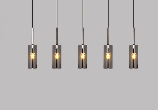 Tatva Lights Modern Pendant Drop featuring a sleek, elongated design with a minimalist metallic finish and soft LED illumination—ideal for kitchen islands, dining areas, or contemporary interior settings.