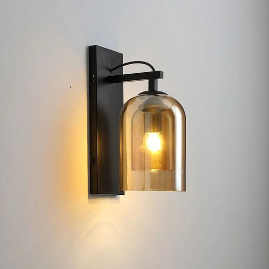 Tatva Lights Aureo Glass Globe Wall Light featuring a gold-finished frame and frosted glass sphere, ideal for adding a warm, ambient glow to bedrooms, hallways, and modern living spaces.
