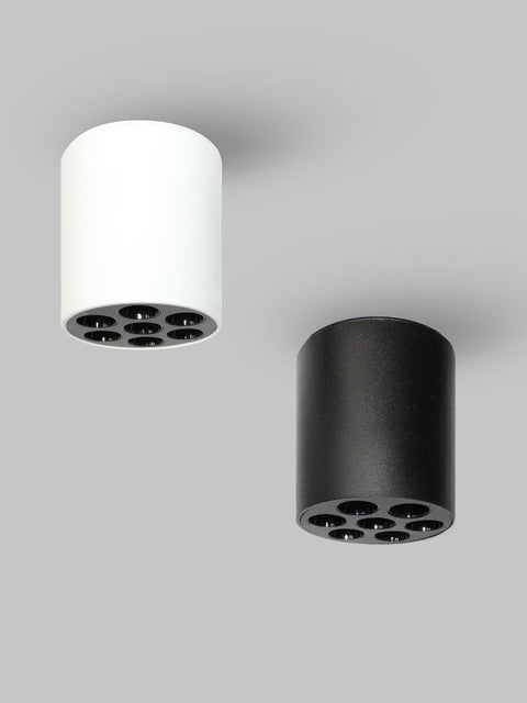 Tatva Lights Elegance Surface LED Downlight shown in black and white cylindrical designs, featuring a sleek, modern form with six recessed LED lights. Ideal for surface mounting on ceilings, the downlights provide focused, ambient illumination for contemporary interiors.