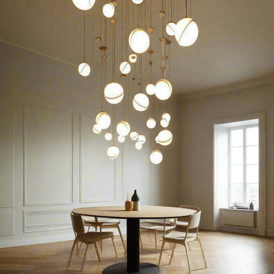 Tatva Lights 3-light modern globe pendant with sleek gold accents and frosted glass orbs – ideal for ambient lighting in kitchens, dining areas, and living spaces