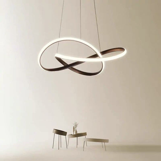 Tatva Lights "Oriona" Luxury Gold Modern LED Chandelier featuring a dynamic ring design with a brushed gold finish and integrated LED lighting—ideal for contemporary living rooms, dining areas, and upscale interiors.